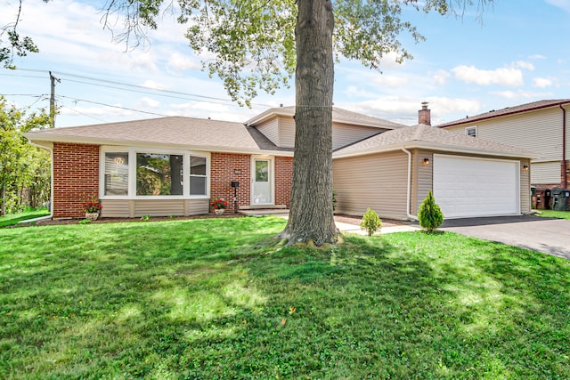 ranch-style home featuring a front lawn and a garage