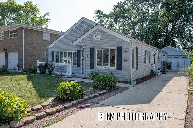 view of front of property with a garage and a front lawn