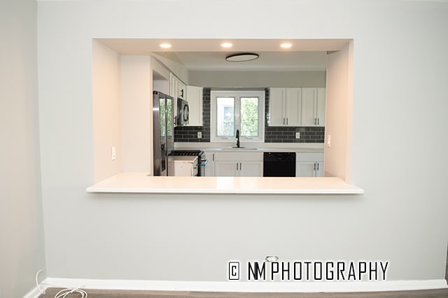 kitchen featuring backsplash, white cabinetry, sink, and stainless steel appliances