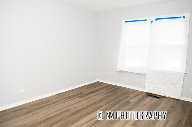 empty room featuring dark wood-type flooring