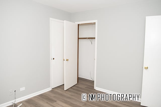 unfurnished bedroom featuring hardwood / wood-style floors and a closet