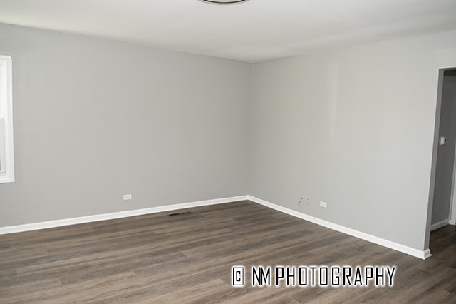 unfurnished room featuring dark hardwood / wood-style floors