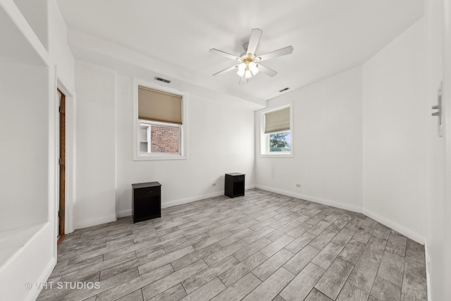 spare room featuring ceiling fan and light hardwood / wood-style flooring