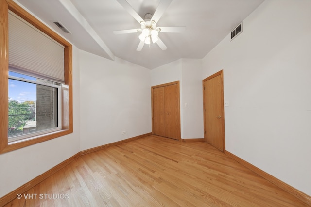 empty room with ceiling fan and light hardwood / wood-style flooring