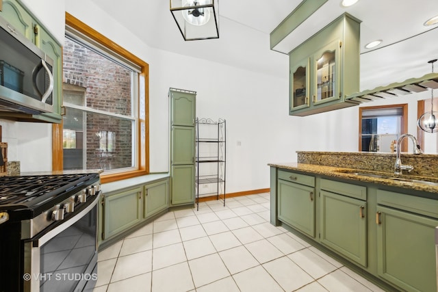 kitchen with a wealth of natural light, sink, stainless steel appliances, and green cabinetry