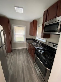 kitchen with light hardwood / wood-style flooring, sink, and appliances with stainless steel finishes