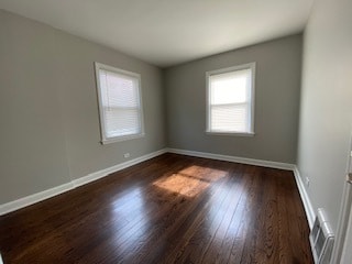 spare room with dark wood-type flooring