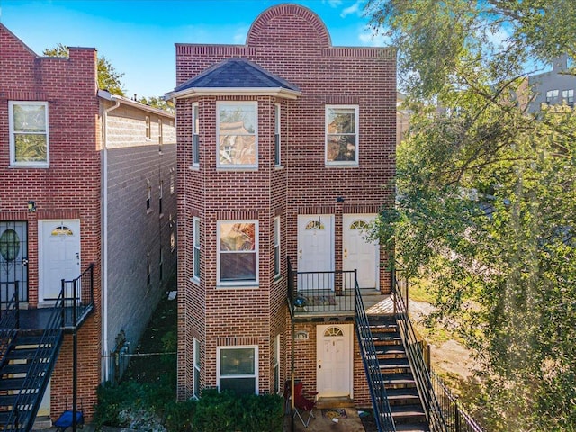 1403 E 71st Pl, Chicago, IL 60619 - townhome / multi-family property featuring stairs, brick siding, and roof with shingles