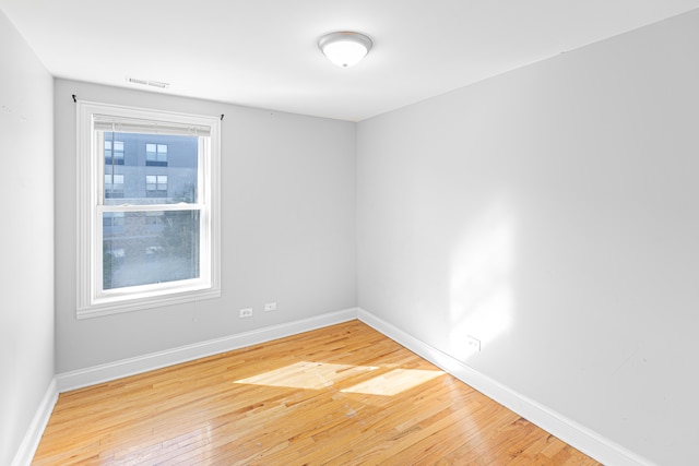 unfurnished room featuring hardwood / wood-style flooring