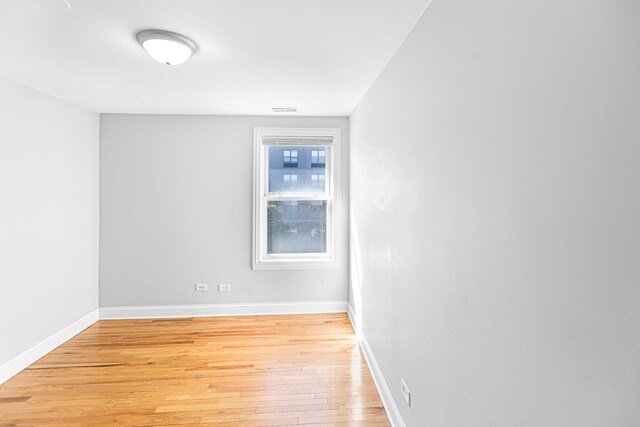 empty room with light hardwood / wood-style floors