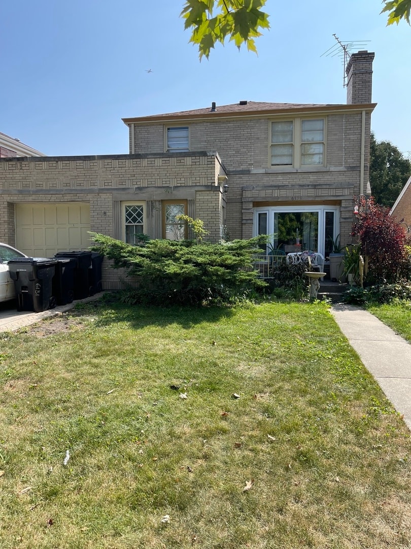 front of property featuring a garage and a front lawn