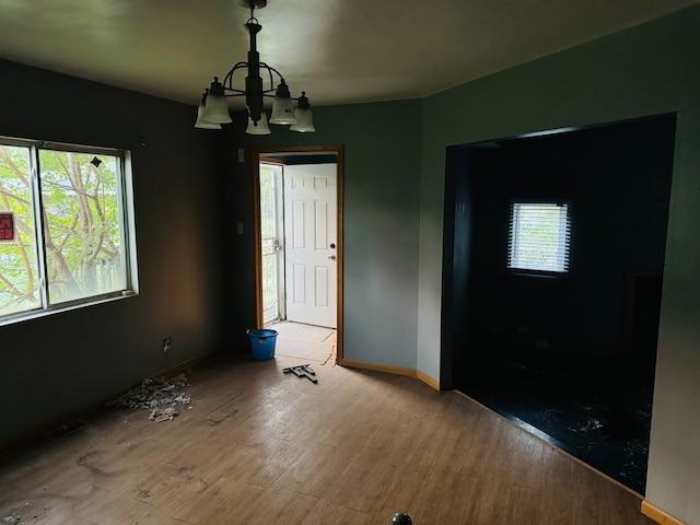 foyer with an inviting chandelier and hardwood / wood-style flooring