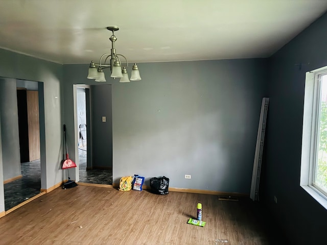 interior space with hardwood / wood-style flooring and a chandelier