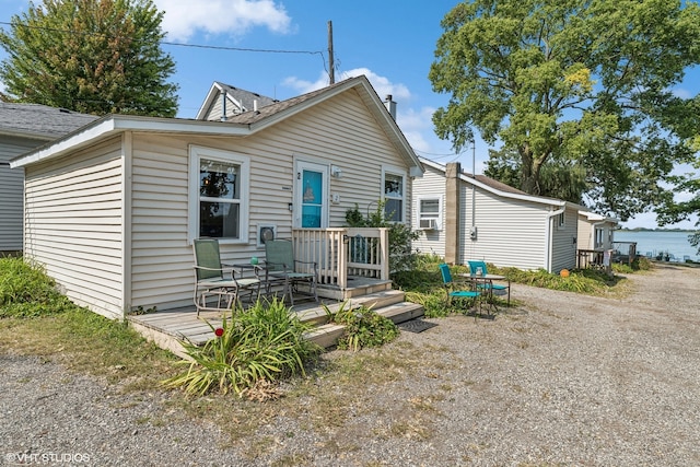 view of front of house featuring cooling unit and a wooden deck