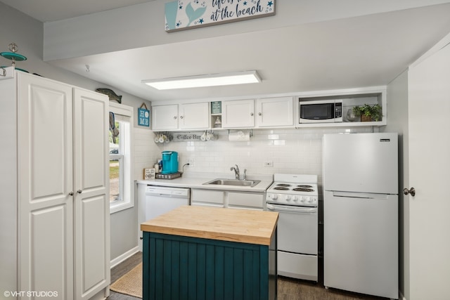 kitchen with wood counters, dark wood-type flooring, sink, white cabinets, and white appliances