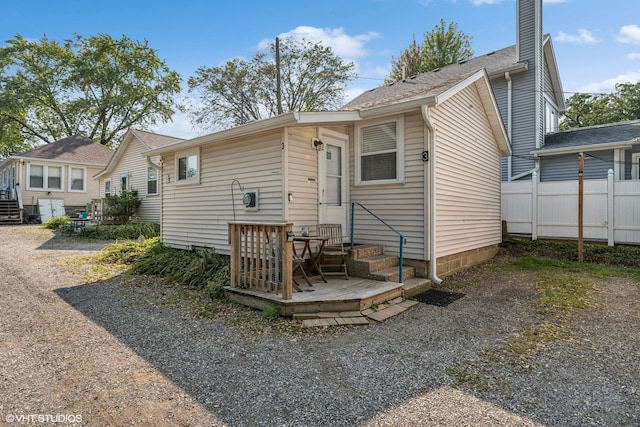 rear view of house featuring a deck