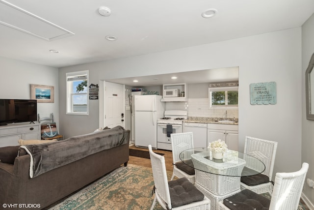 dining area with a healthy amount of sunlight, hardwood / wood-style floors, and sink