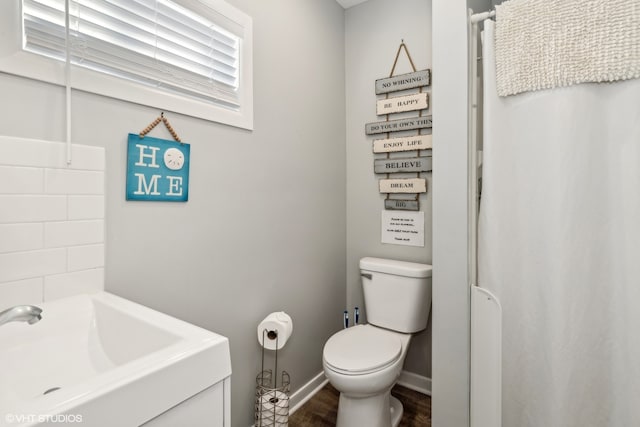 bathroom featuring hardwood / wood-style floors, toilet, and sink