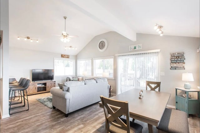 dining area with wood-type flooring, lofted ceiling, and ceiling fan