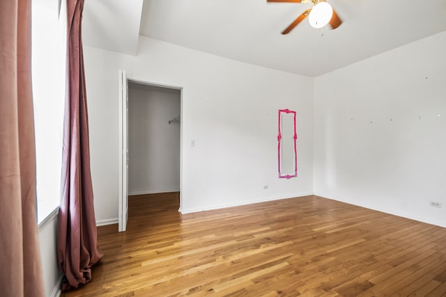 empty room with ceiling fan and light hardwood / wood-style floors