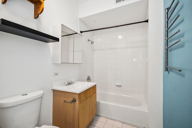 full bathroom featuring tile patterned flooring, toilet, tiled shower / bath combo, and vanity