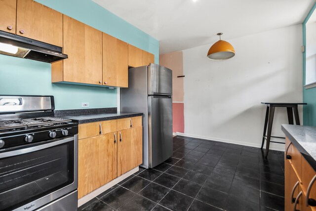 kitchen featuring appliances with stainless steel finishes and dark tile patterned floors