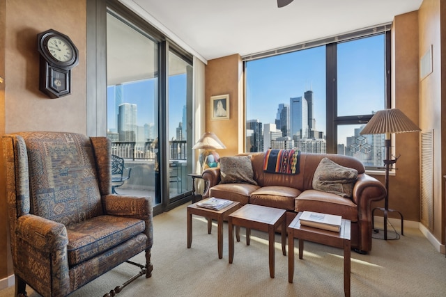 carpeted living room with floor to ceiling windows and a healthy amount of sunlight