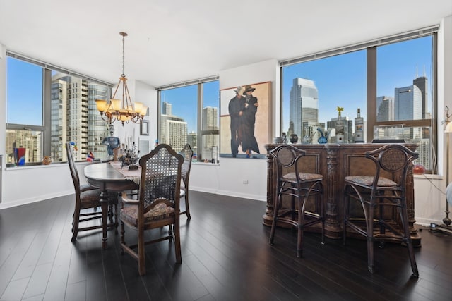 dining area featuring dark wood-type flooring and an inviting chandelier