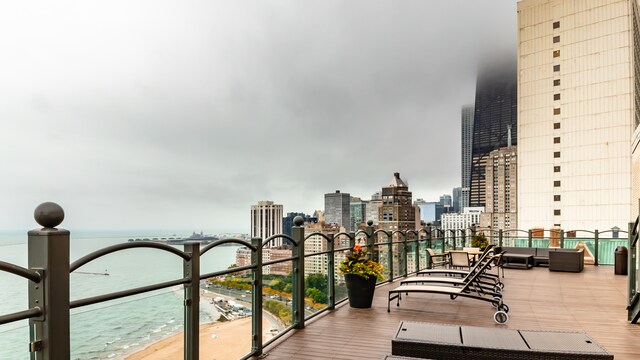 deck with a beach view and a water view