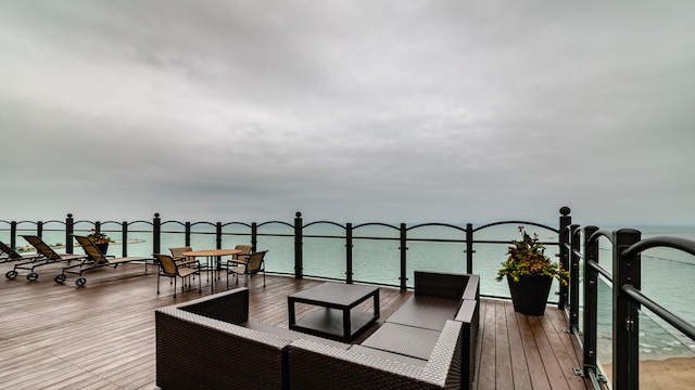 wooden deck featuring a water view and an outdoor hangout area