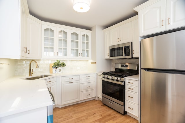 kitchen with white cabinets, appliances with stainless steel finishes, and sink