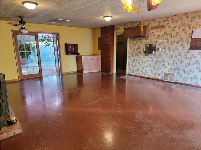 unfurnished living room with ceiling fan