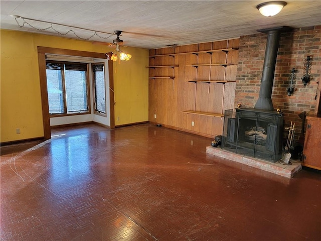 unfurnished living room featuring dark wood-type flooring and a wood stove