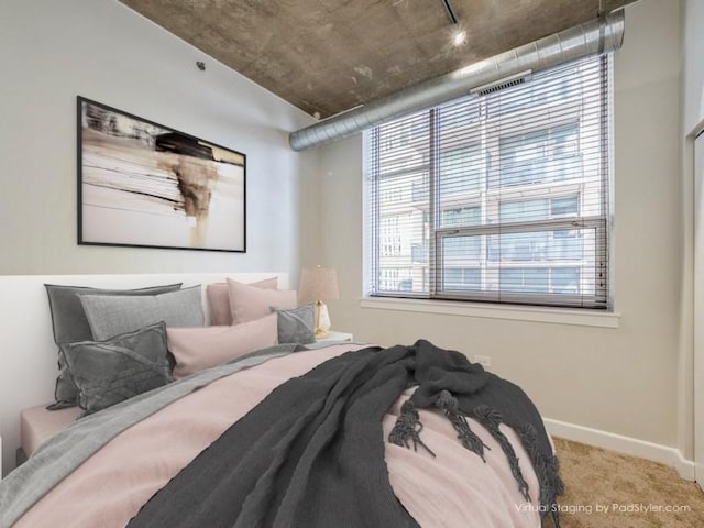 bedroom featuring multiple windows and carpet flooring