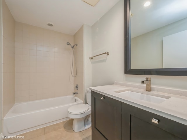 full bathroom featuring vanity, toilet, tiled shower / bath combo, and tile patterned flooring