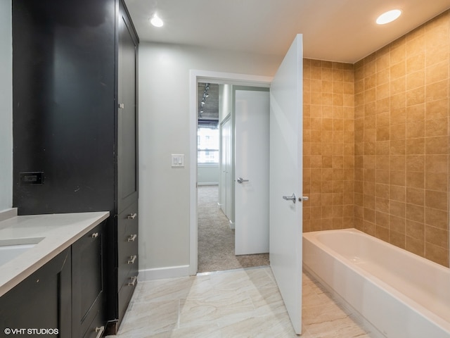 bathroom with vanity and tiled shower / bath combo