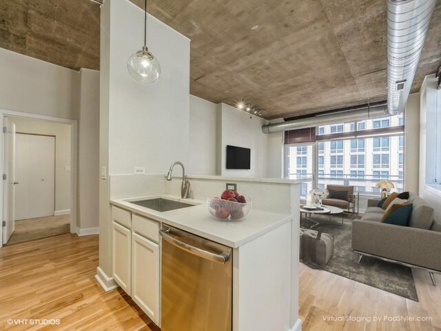 kitchen featuring white cabinetry, light wood-type flooring, dishwasher, pendant lighting, and sink