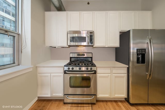 kitchen featuring white cabinetry, light hardwood / wood-style floors, and appliances with stainless steel finishes