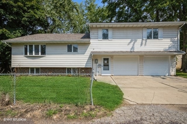 split level home featuring a garage and a front yard