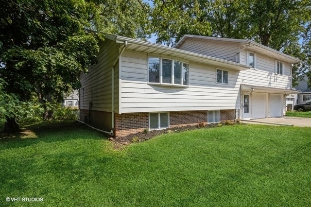 exterior space with a garage and a front lawn