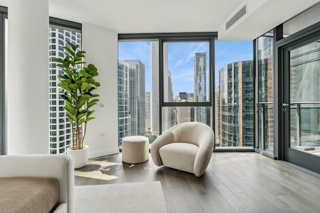 interior space featuring a wall of windows and hardwood / wood-style floors