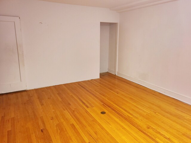 unfurnished room with light wood-type flooring