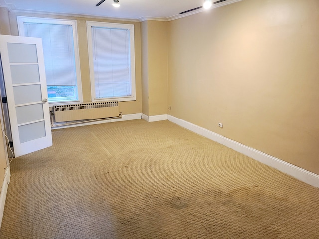 interior space featuring radiator heating unit, ornamental molding, and carpet flooring