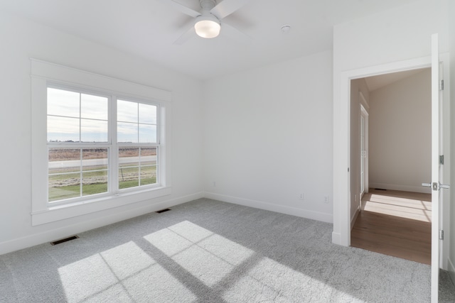 spare room with ceiling fan and hardwood / wood-style flooring