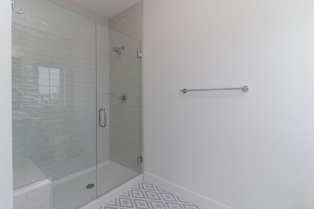 bathroom with a shower with shower door