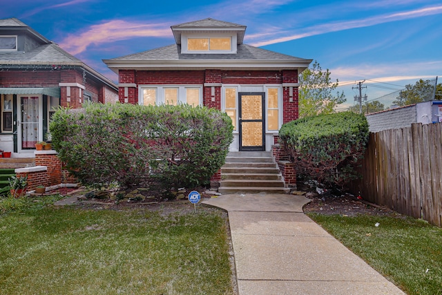 bungalow-style house with a yard