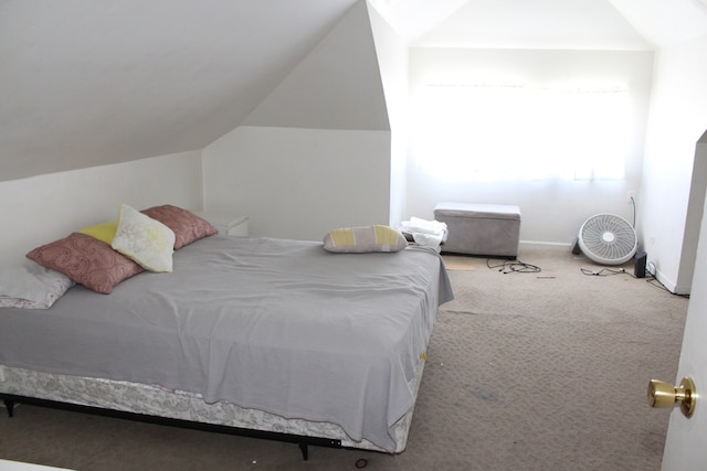 bedroom featuring light carpet and lofted ceiling