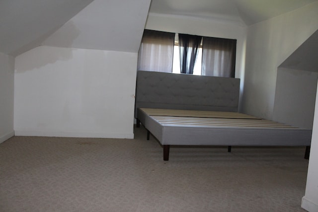 unfurnished room with carpet floors and vaulted ceiling