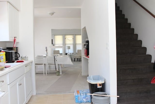 interior space featuring white cabinetry, white dishwasher, and sink