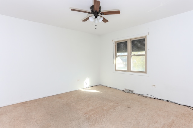 unfurnished room with light colored carpet and ceiling fan